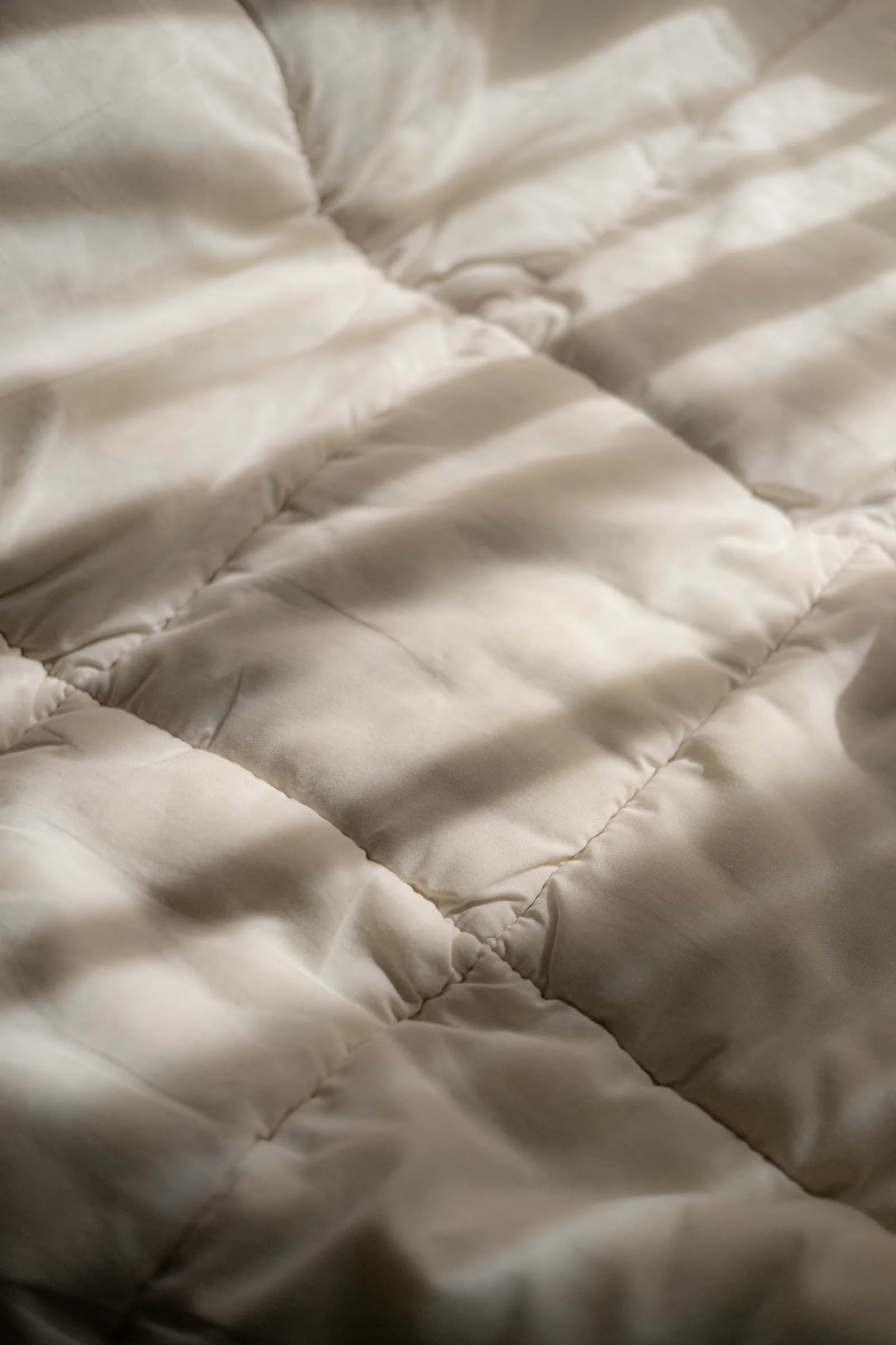 White linen with bands of sunlight and shadow across it