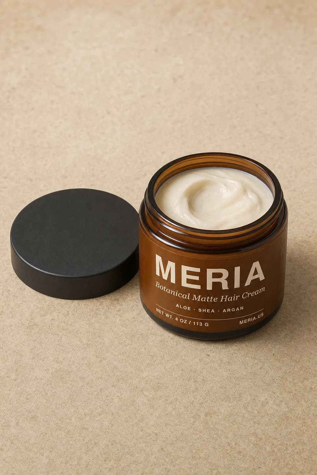 An opened Meria jar with its lid resting beside it and the cream visible inside.