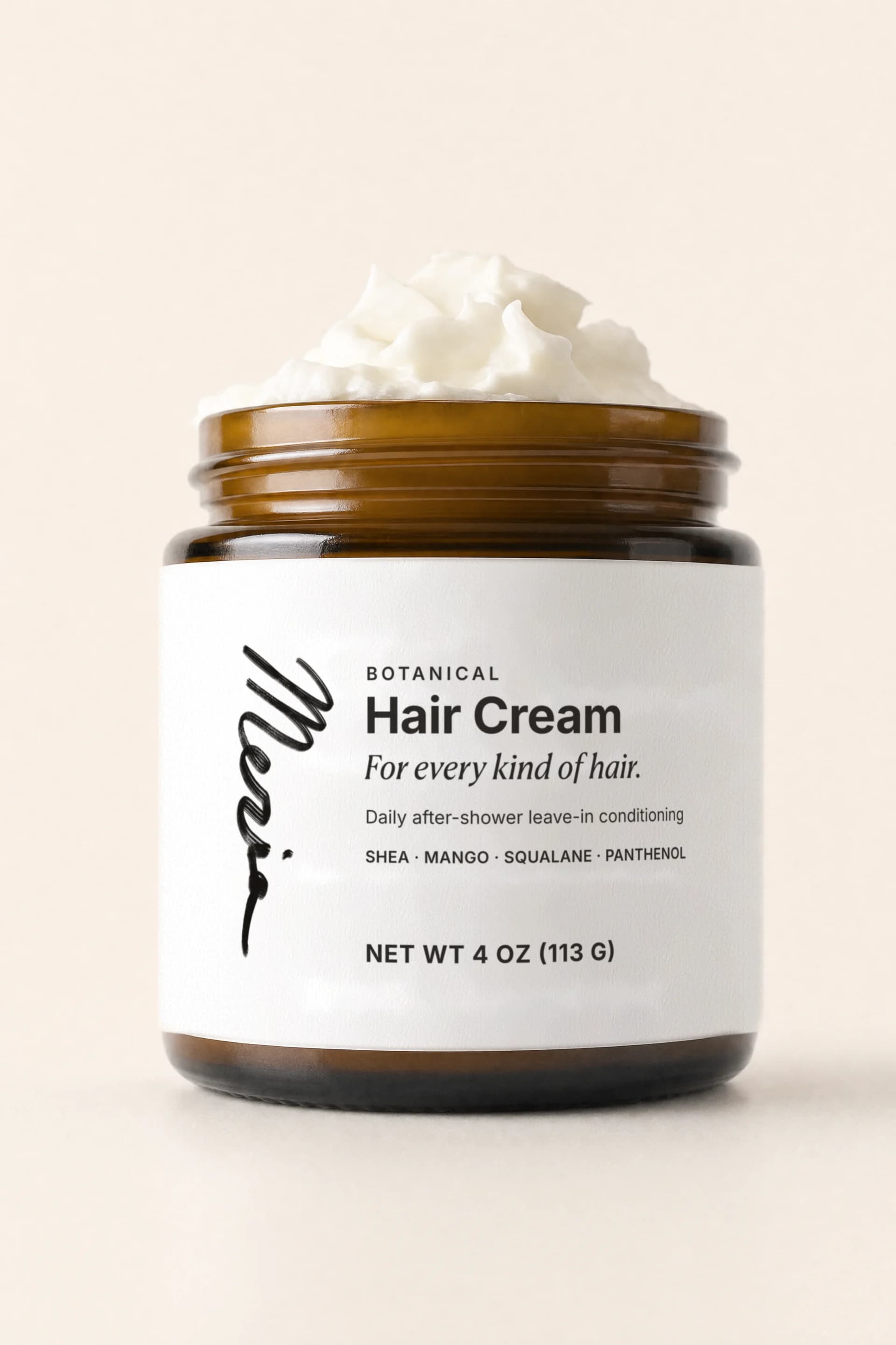 The open jar of hair cream at eye level, its whole front label facing the camera