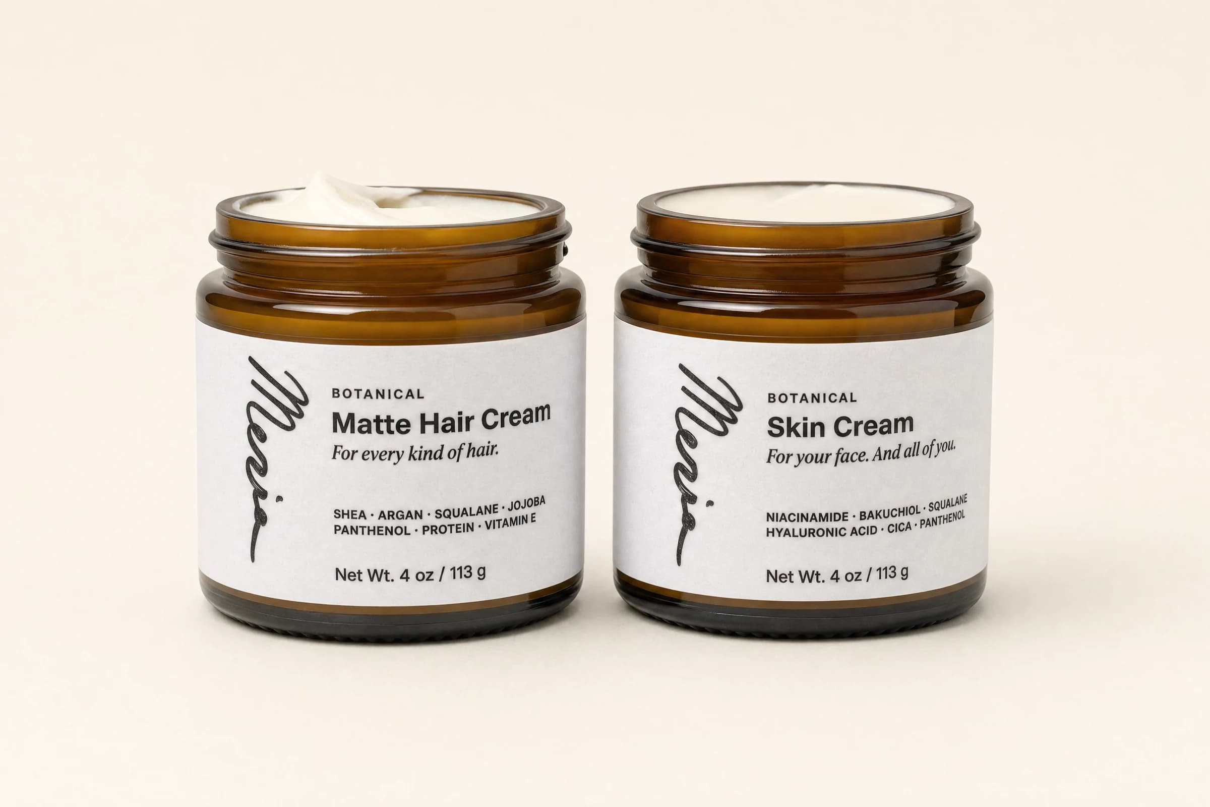Meria Botanical Skin Cream and Botanical Matte Hair Cream, side by side in amber glass