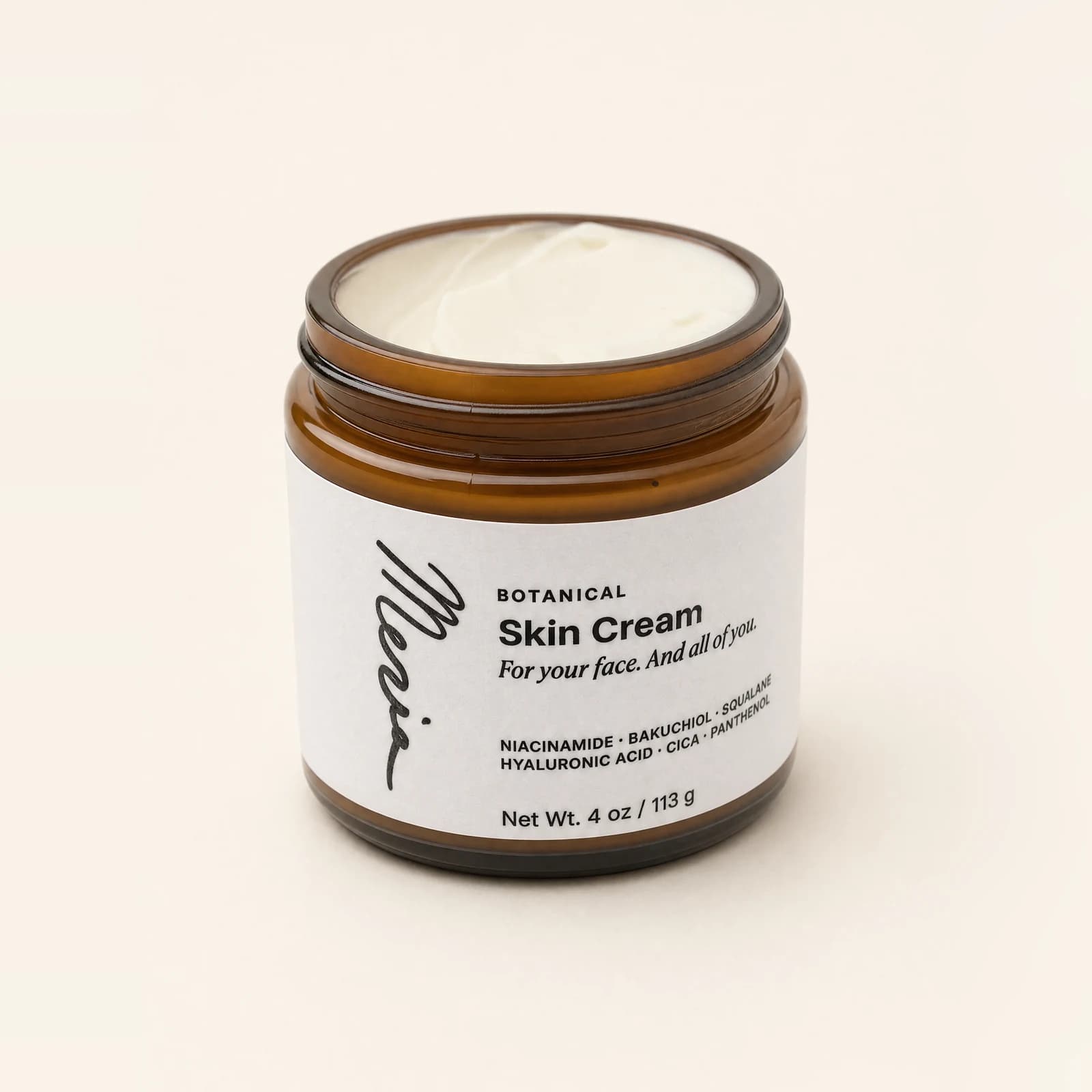 An open jar of Meria Botanical Skin Cream seen from above, the cream visible, on a plain studio backdrop